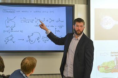 Professor Newhouse uses digital screens in the TEAL classroom to enhance his class